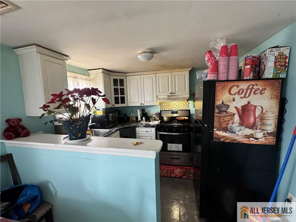 111 Delavan Street New Brunswick, NJ 08901 - Photo 20 of 28 a kitchen with a sink and cabinets