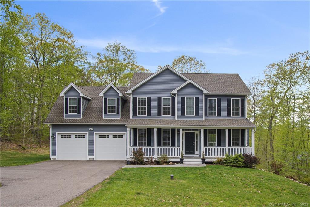 a aerial view of a house with a yard potted plants and a bench