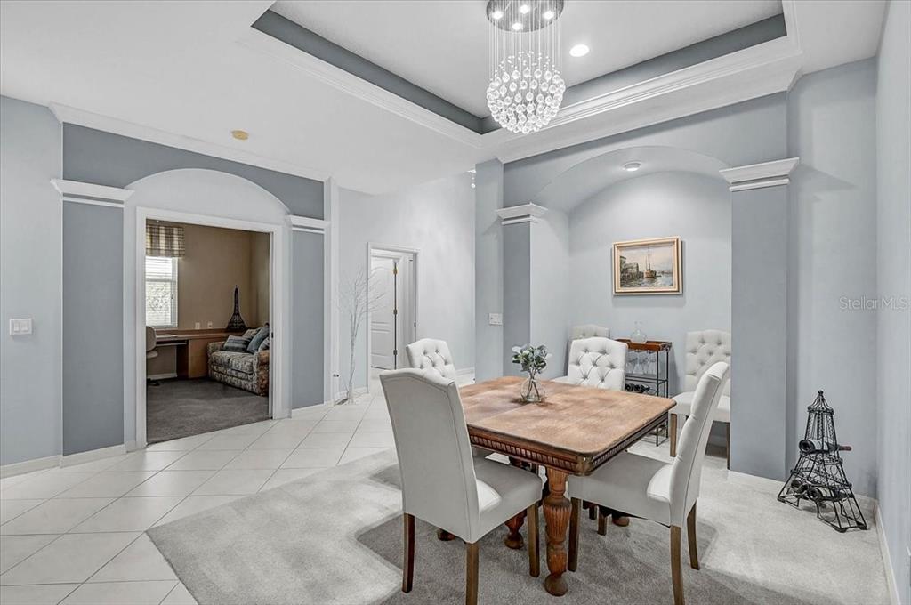 103 Bishopscourt Road Osprey, FL 34229 - Photo 5 of 55 a view of a dining room with furniture and a chandelier