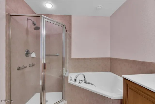 a bathroom with a tub a sink and a shower