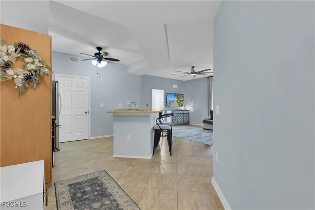 a view of a workspace with furniture and a chandelier