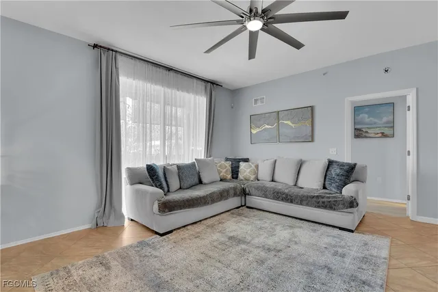 a living room with furniture and a large window
