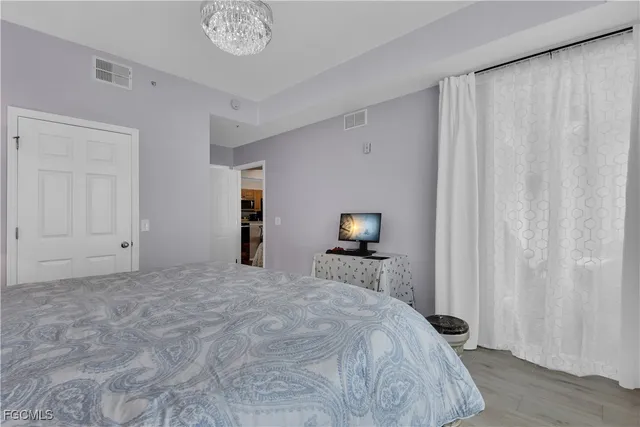 a bedroom with a bed and a tv on table