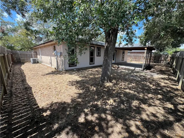 a view of a house with a tree in the background