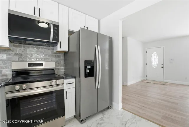 a bathroom with a granite countertop sink a window and a mirror