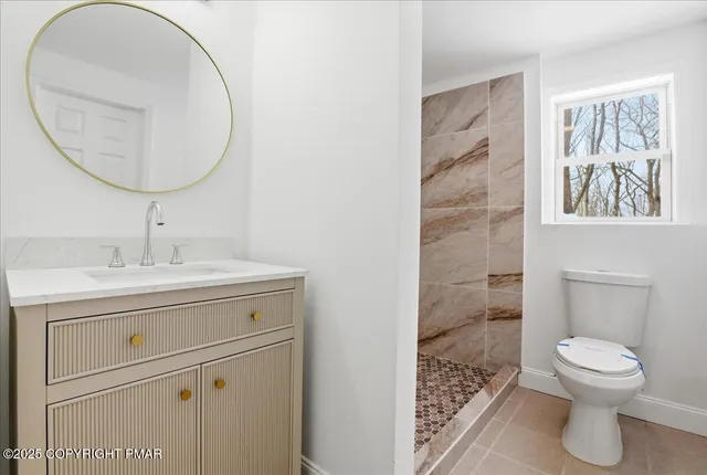 a bathroom with a toilet and a shower