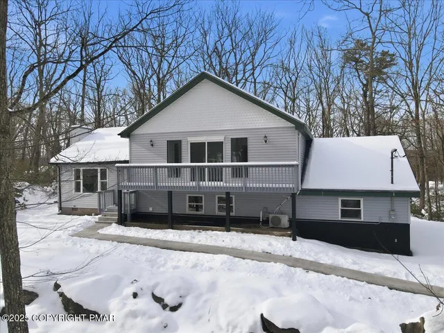 a view of a house with wooden deck
