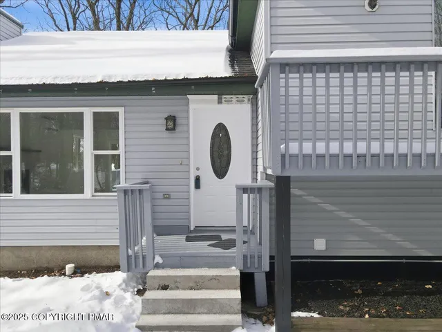 a view of a house with wooden fence