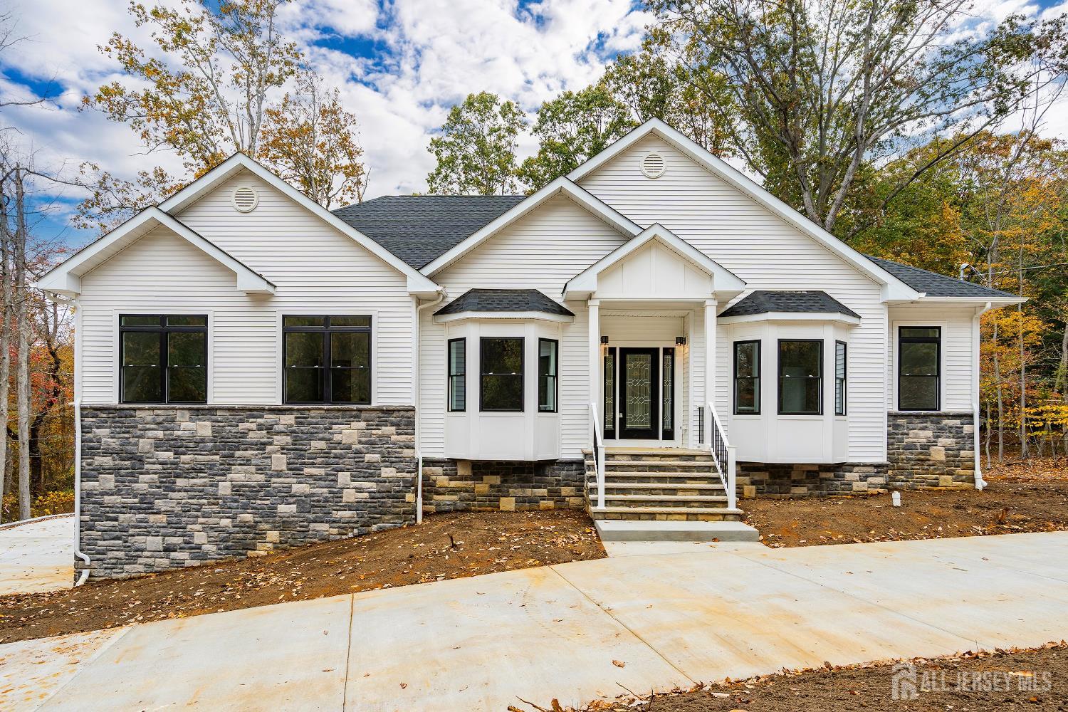 34 Mill Road Manalapan, NJ 07726 - Photo 1 of 30 a front view of a house with a garage