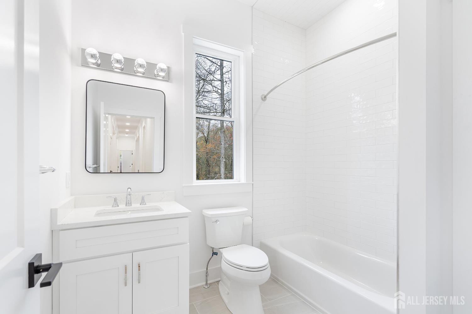 34 Mill Road Manalapan, NJ 07726 - Photo 17 of 30 a bathroom with a toilet sink and mirror