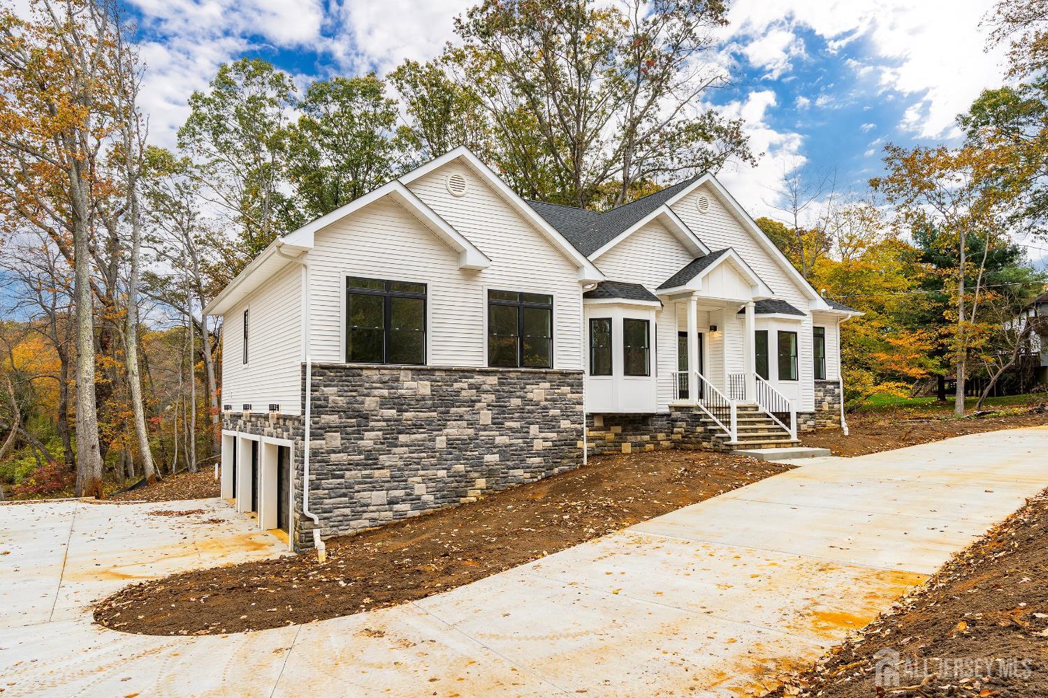 34 Mill Road Manalapan, NJ 07726 - Photo 21 of 30 a front view of a house with a yard covered with snow