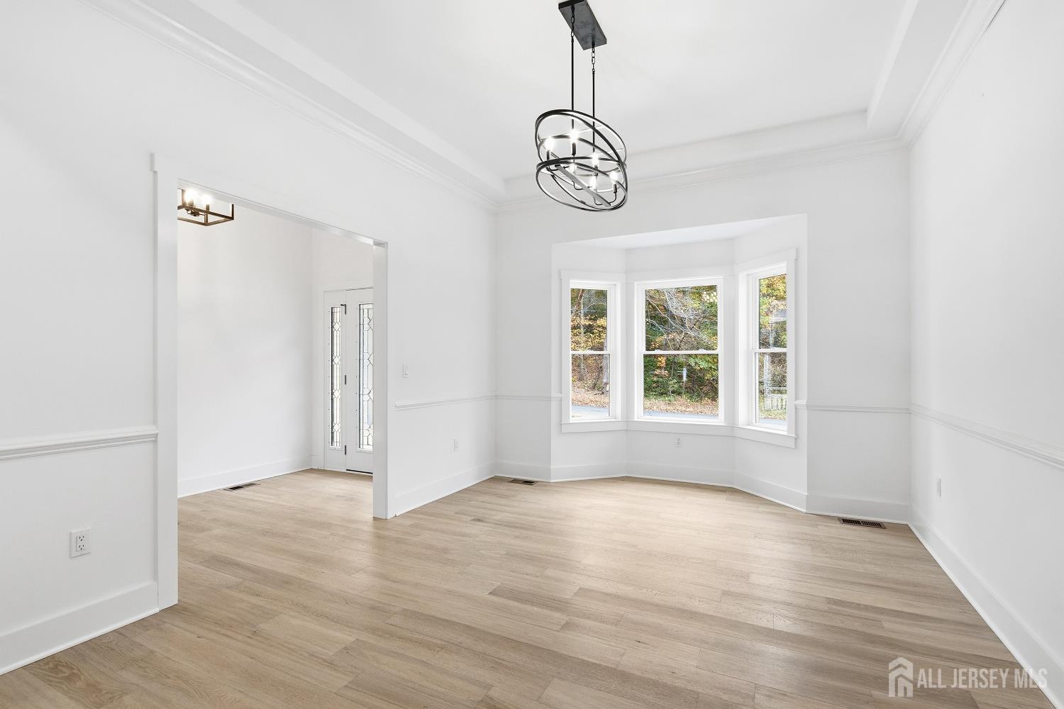 34 Mill Road Manalapan, NJ 07726 - Photo 3 of 30 a view of an empty room with wooden floor and a window