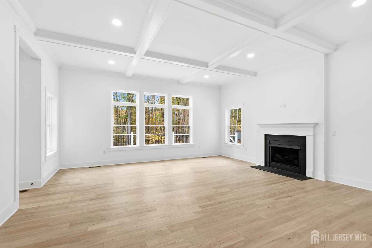 34 Mill Road Manalapan, NJ 07726 - Photo 4 of 30 wooden floor fireplace and windows in an empty room
