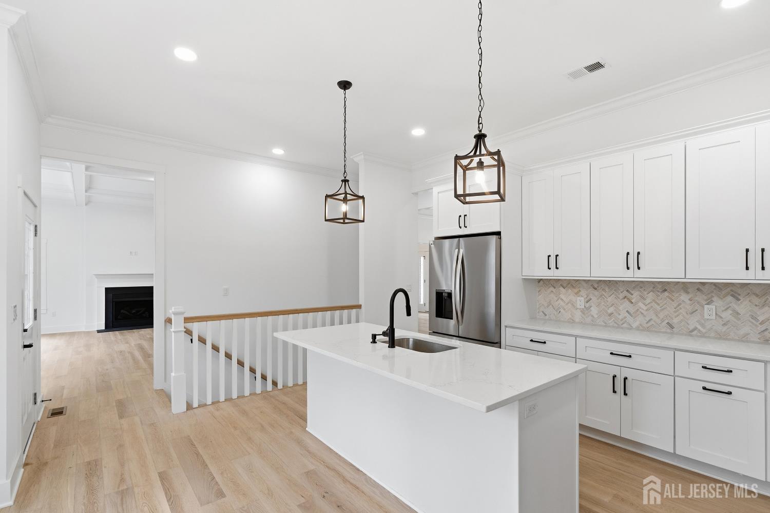 34 Mill Road Manalapan, NJ 07726 - Photo 5 of 30 a kitchen with stainless steel appliances a sink dishwasher a refrigerator and white cabinets with wooden floor
