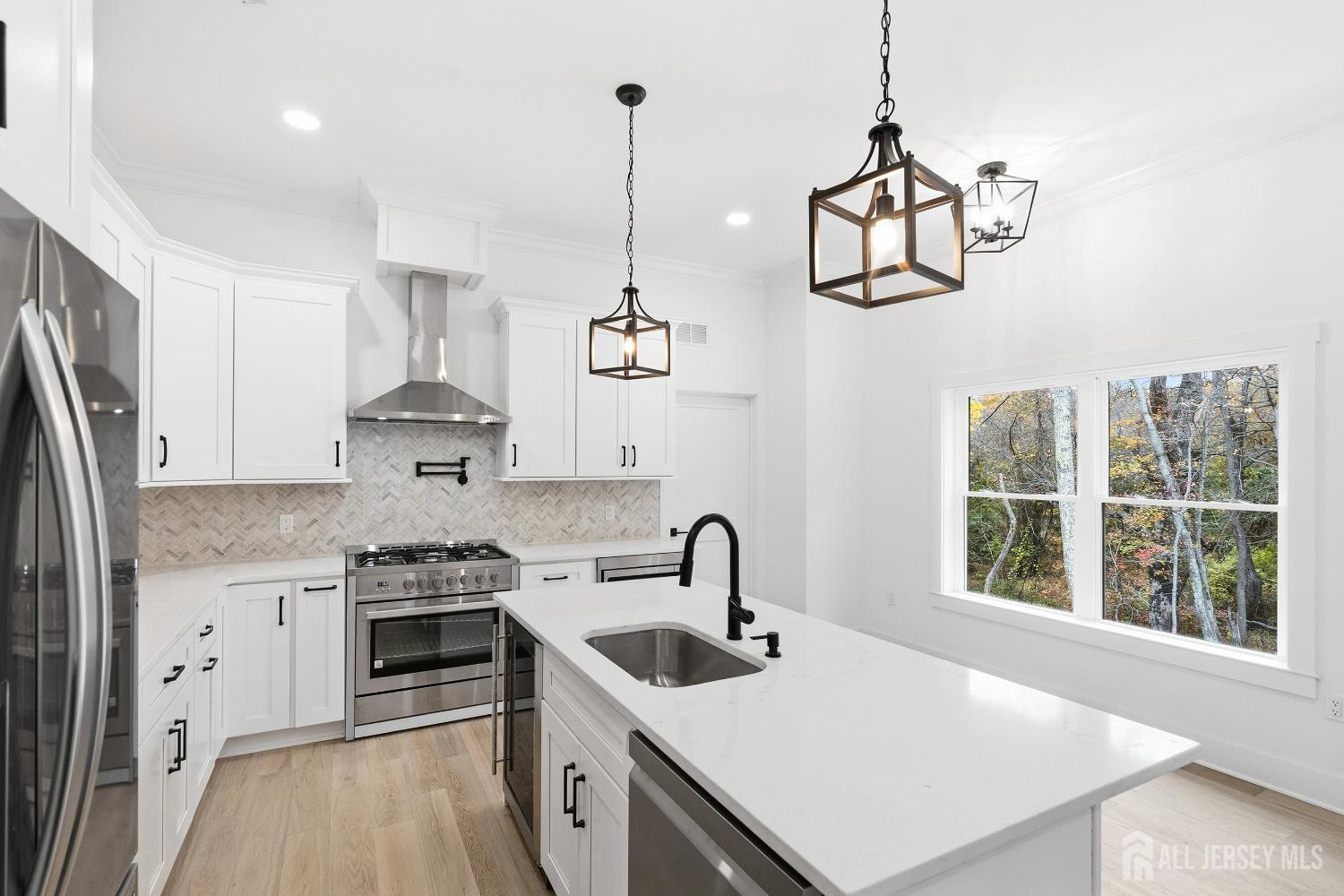 34 Mill Road Manalapan, NJ 07726 - Photo 7 of 30 a kitchen with a stove a sink and a refrigerator