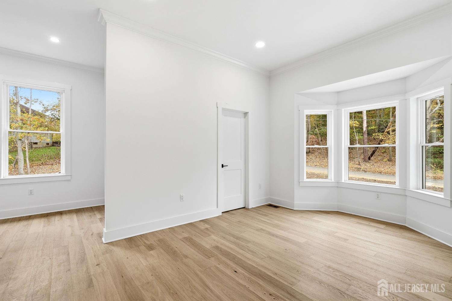 34 Mill Road Manalapan, NJ 07726 - Photo 10 of 30 an empty room with wooden floor and windows