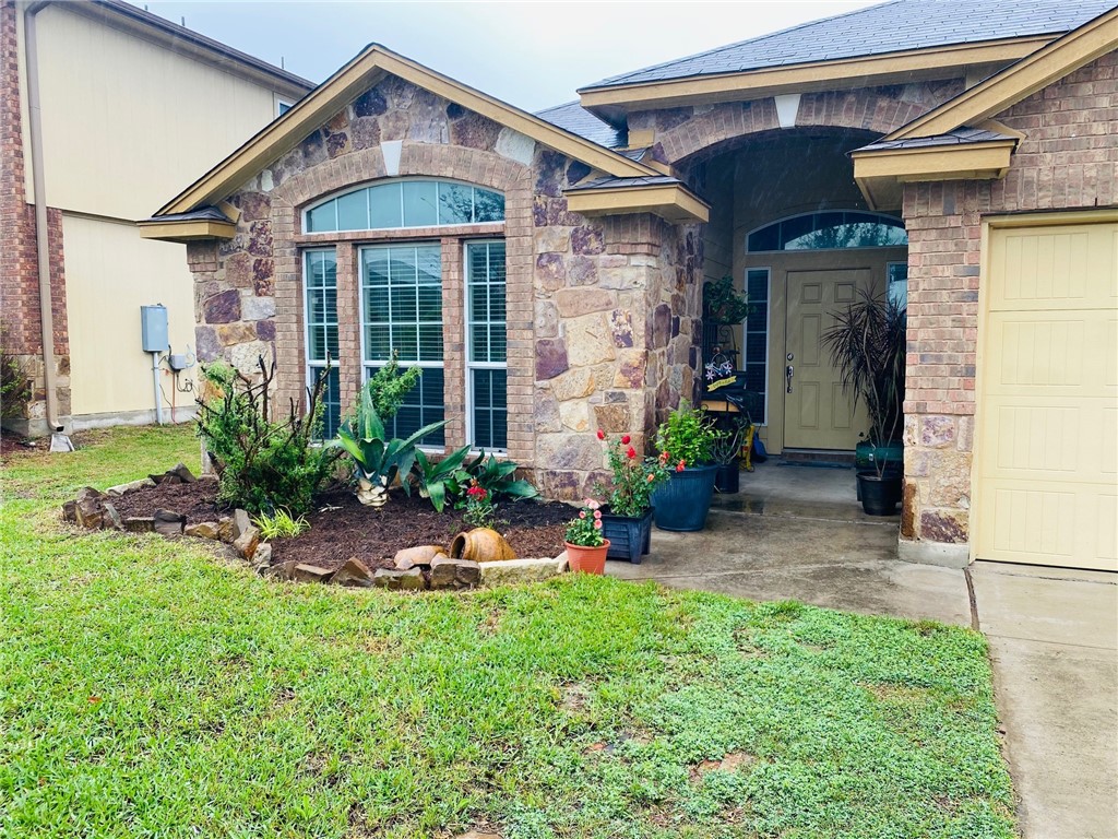 a front view of a house with a yard and porch