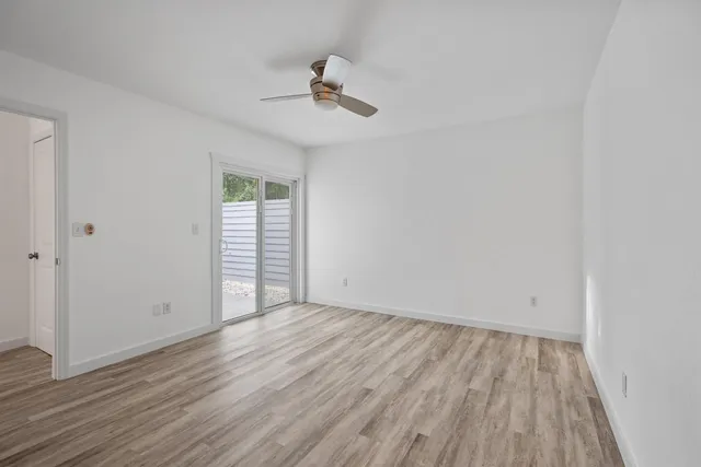 wooden floor in an empty room with a window