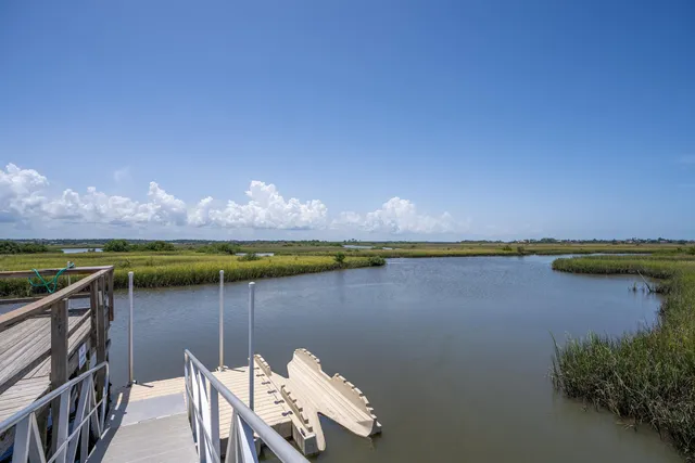 a view of a lake with couches in the patio