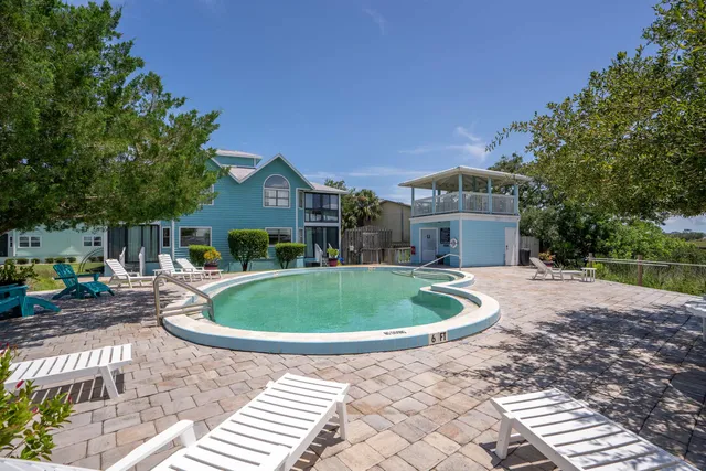 a front view of a house with a garden and patio