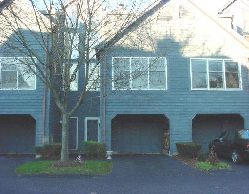 a front view of a house with yard and garage