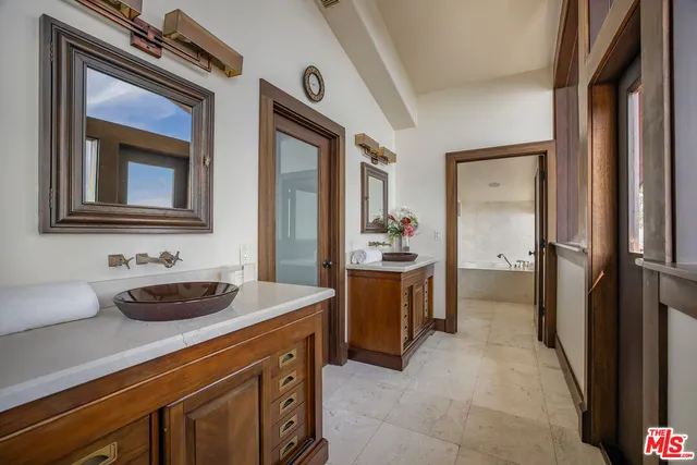 a bedroom with a large bed and a large window