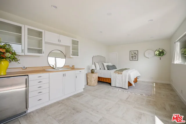 a view of a chair and tables in the balcony