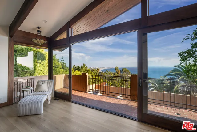 a very nice looking living room with a large window and a table