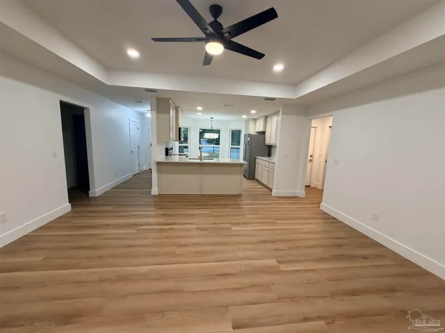 a view of a kitchen with a sink and wooden floor