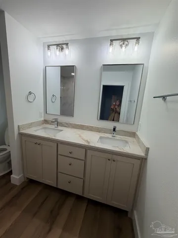 a bathroom with a double vanity sink and a mirror