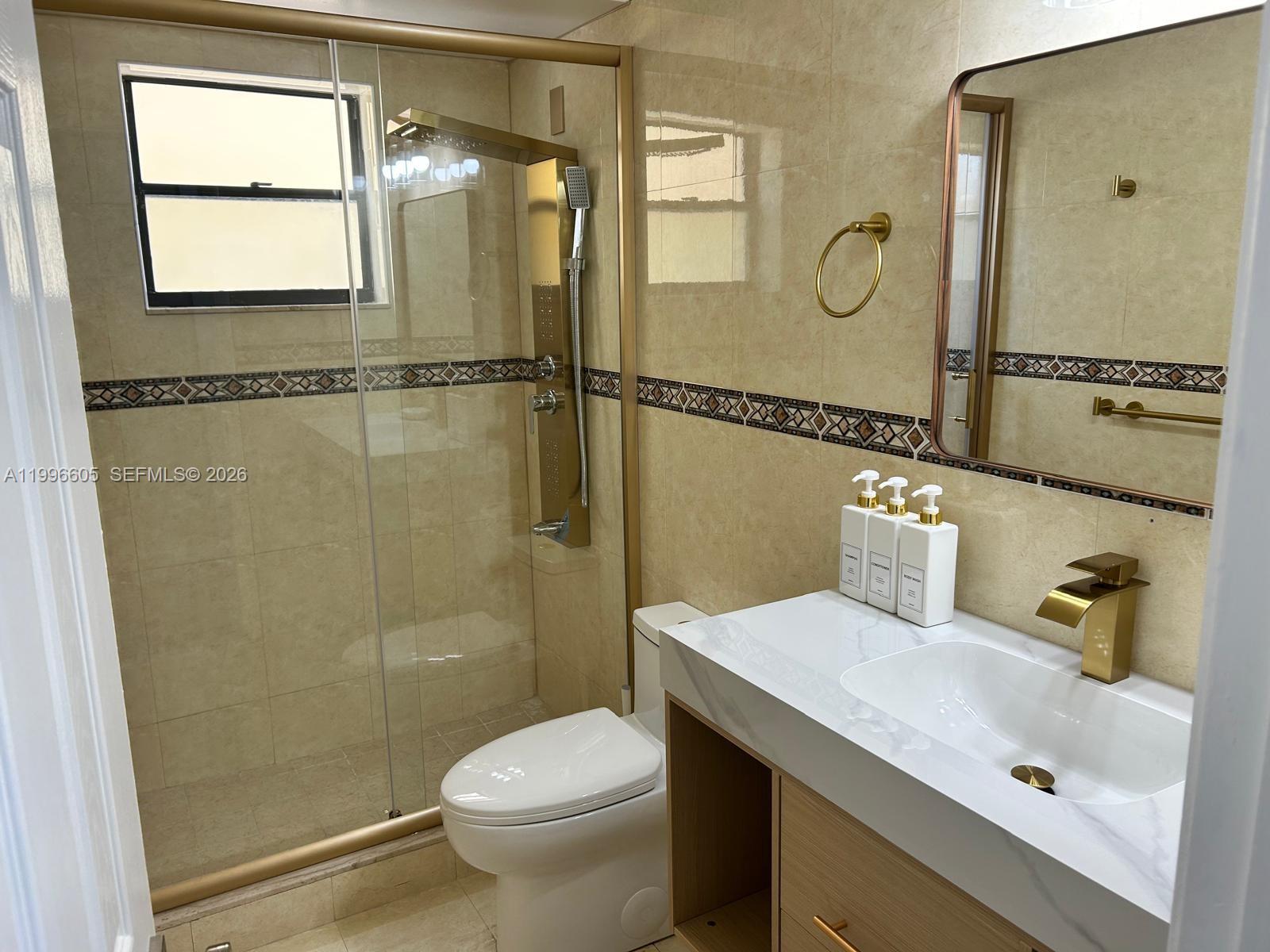9922 Southwest 2nd Street, Unit A Miami, FL 33174 - Photo 14 of 24 a bathroom with a sink and a mirror