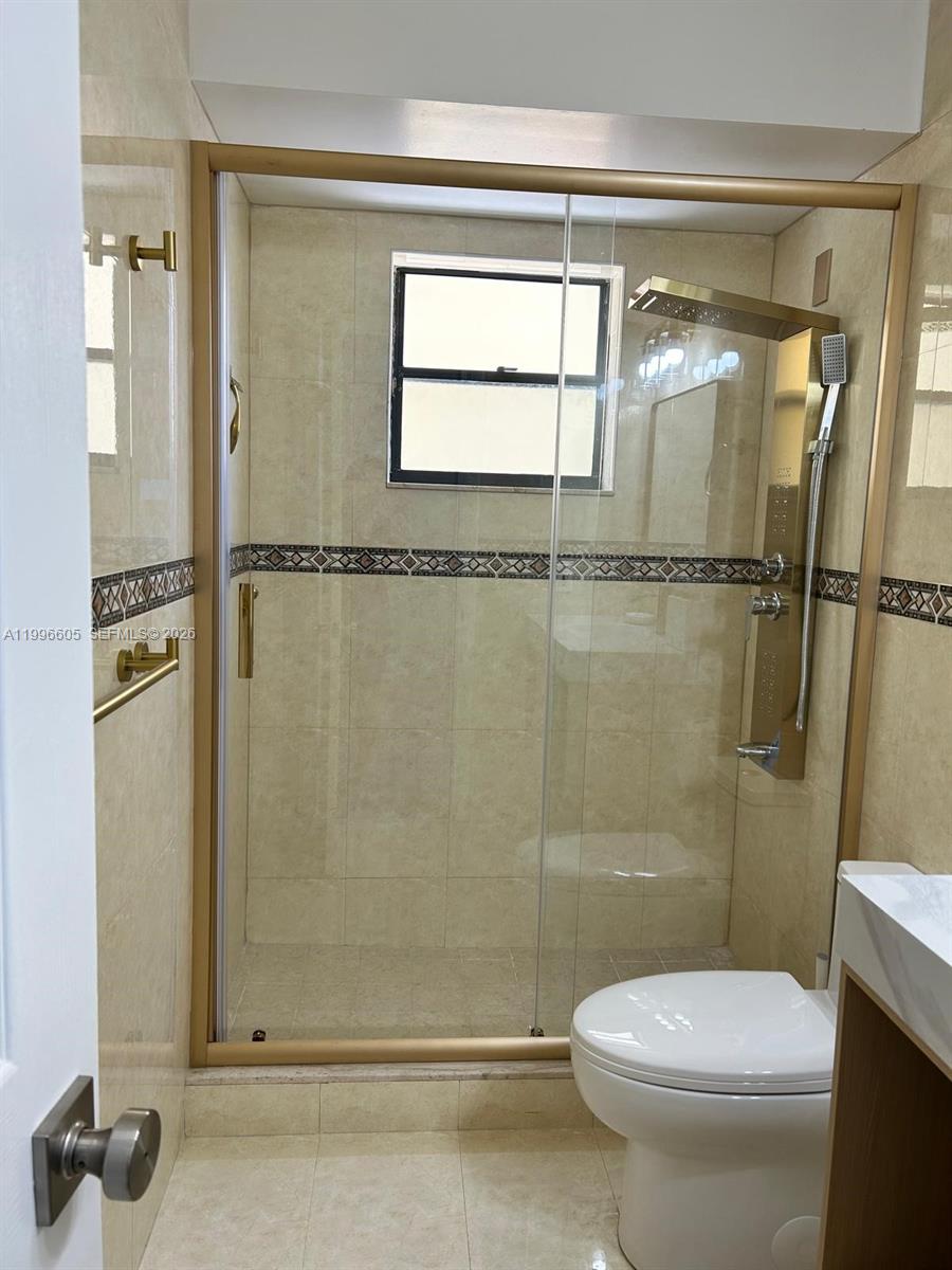 9922 Southwest 2nd Street, Unit A Miami, FL 33174 - Photo 15 of 24 a bathroom with a shower and a toilet