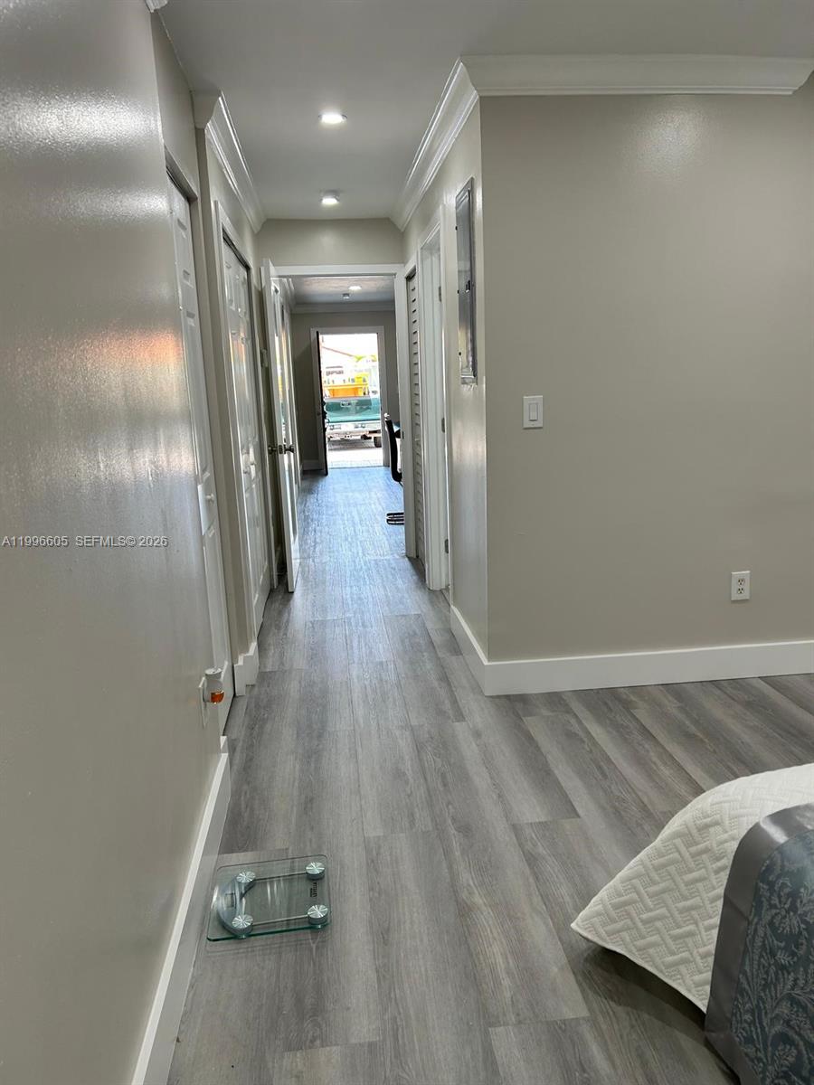 9922 Southwest 2nd Street, Unit A Miami, FL 33174 - Photo 23 of 24 a view of a hallway with wooden floor