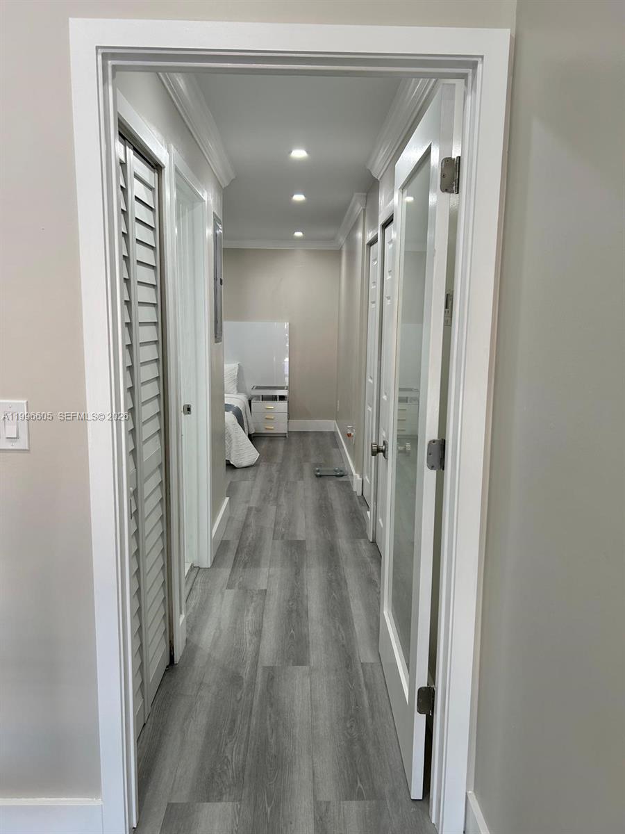 9922 Southwest 2nd Street, Unit A Miami, FL 33174 - Photo 24 of 24 a view of a hallway with wooden floor and staircase