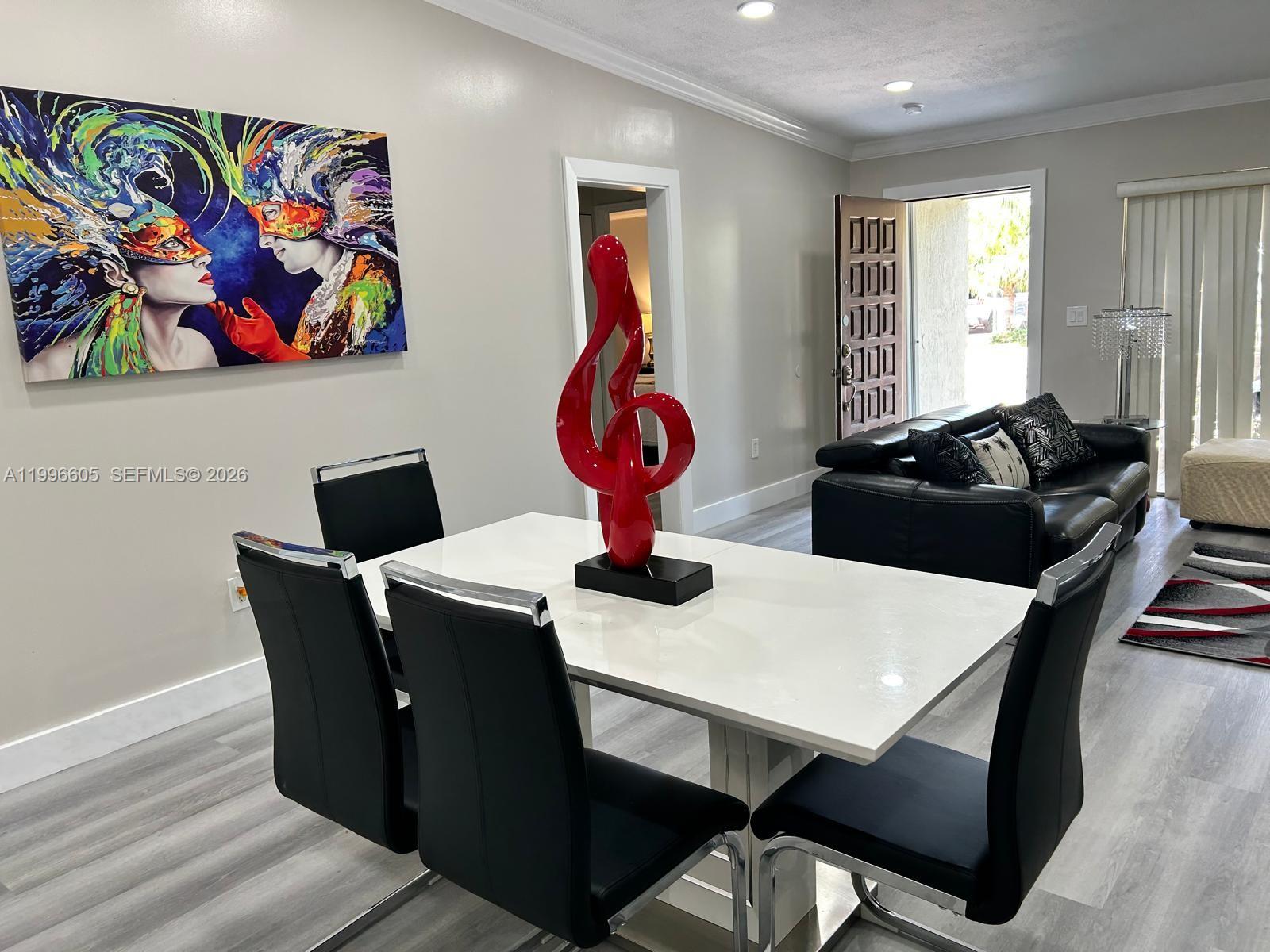 9922 Southwest 2nd Street, Unit A Miami, FL 33174 - Photo 6 of 24 a dining room with furniture and wooden floor