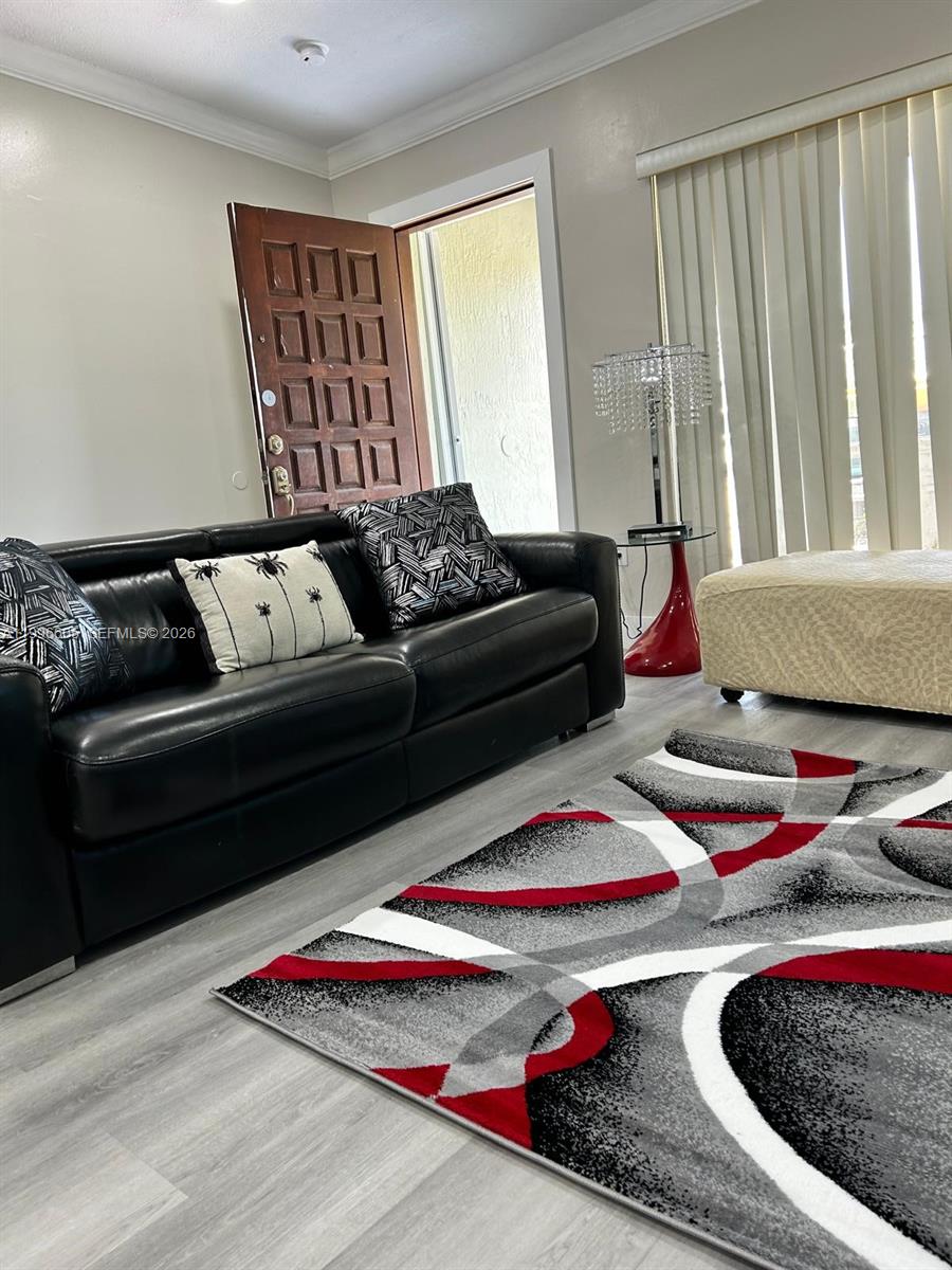 9922 Southwest 2nd Street, Unit A Miami, FL 33174 - Photo 7 of 24 a living room with furniture and a couch