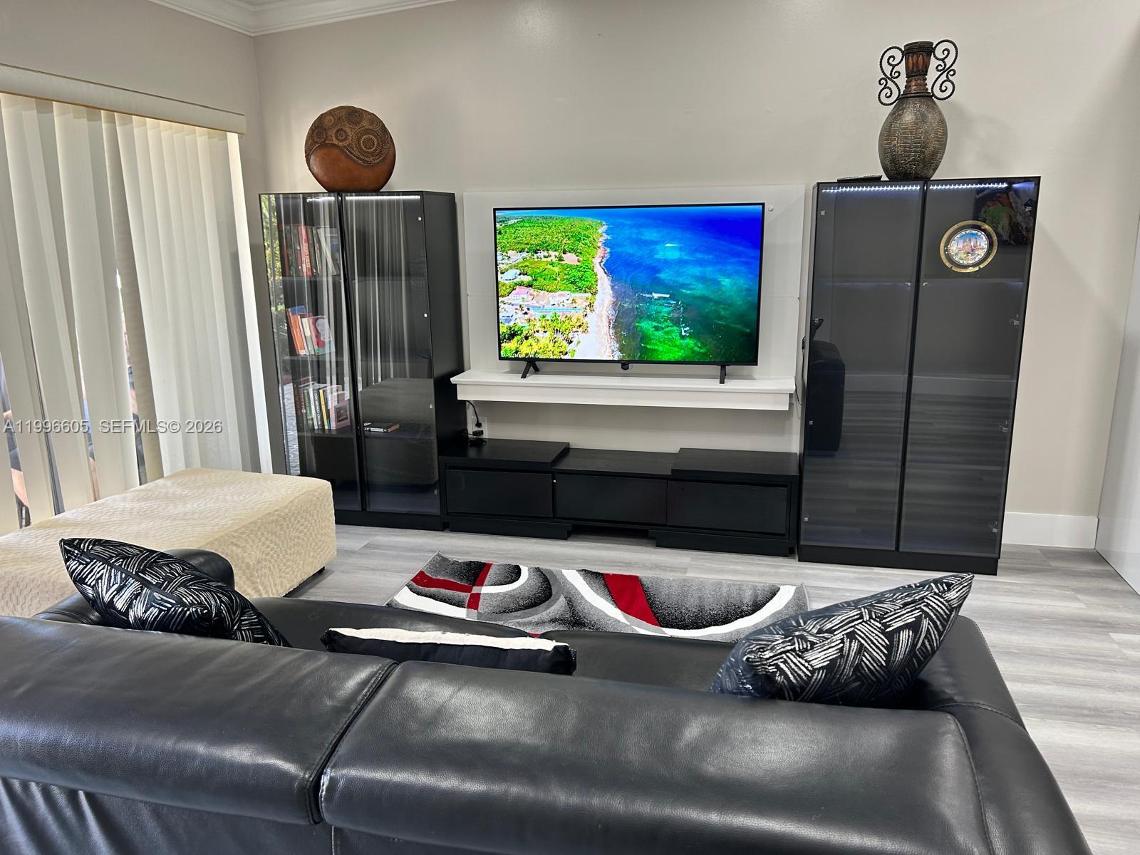 9922 Southwest 2nd Street, Unit A Miami, FL 33174 - Photo 8 of 24 a living room with furniture and a flat screen tv