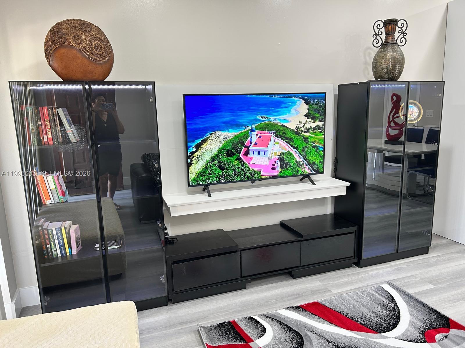 9922 Southwest 2nd Street, Unit A Miami, FL 33174 - Photo 9 of 24 a living room with furniture and a table