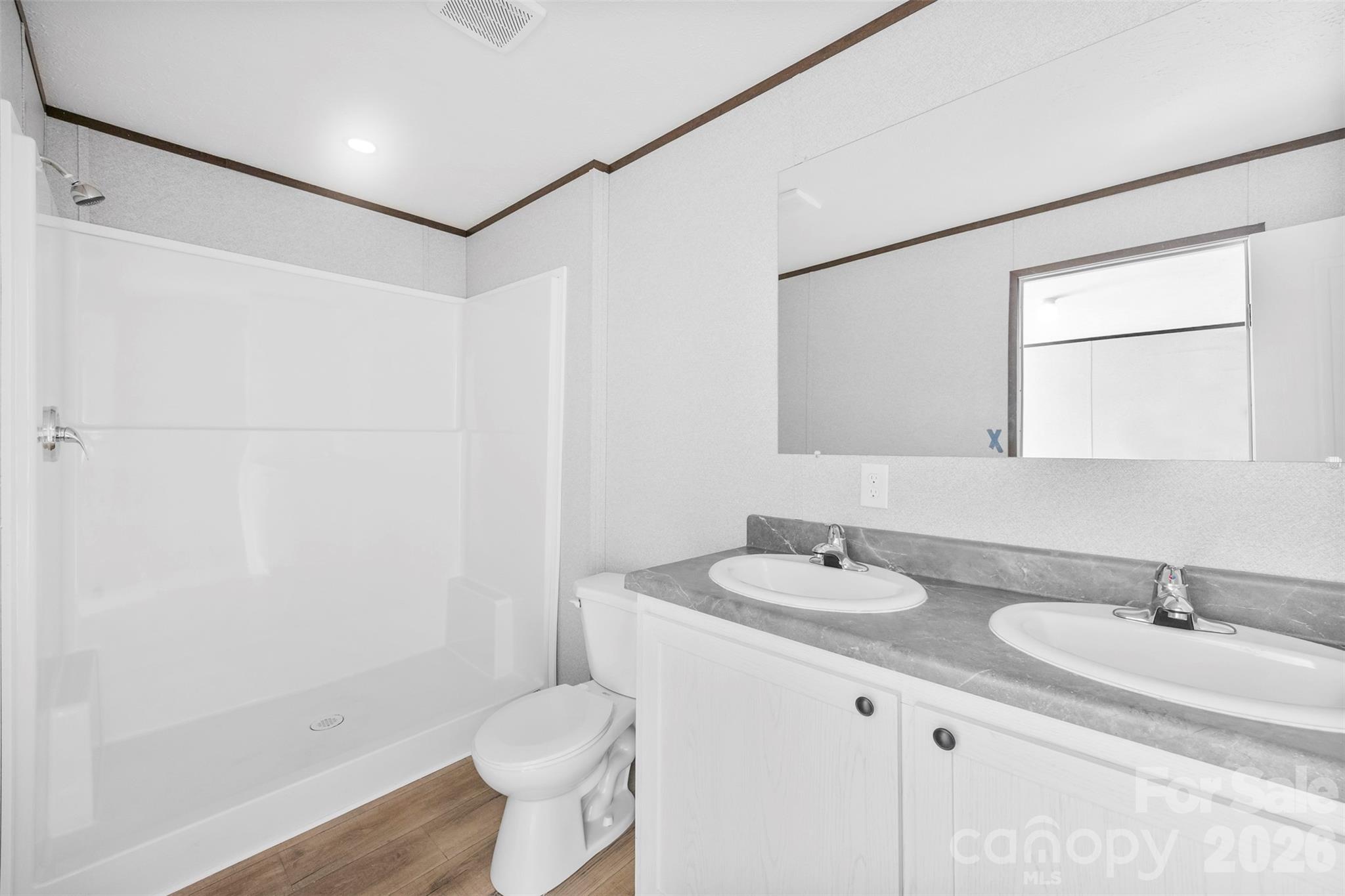 321 Bell Road Kings Mountain, NC 28086 - Photo 17 of 32 a bathroom with a granite countertop sink a toilet and a mirror