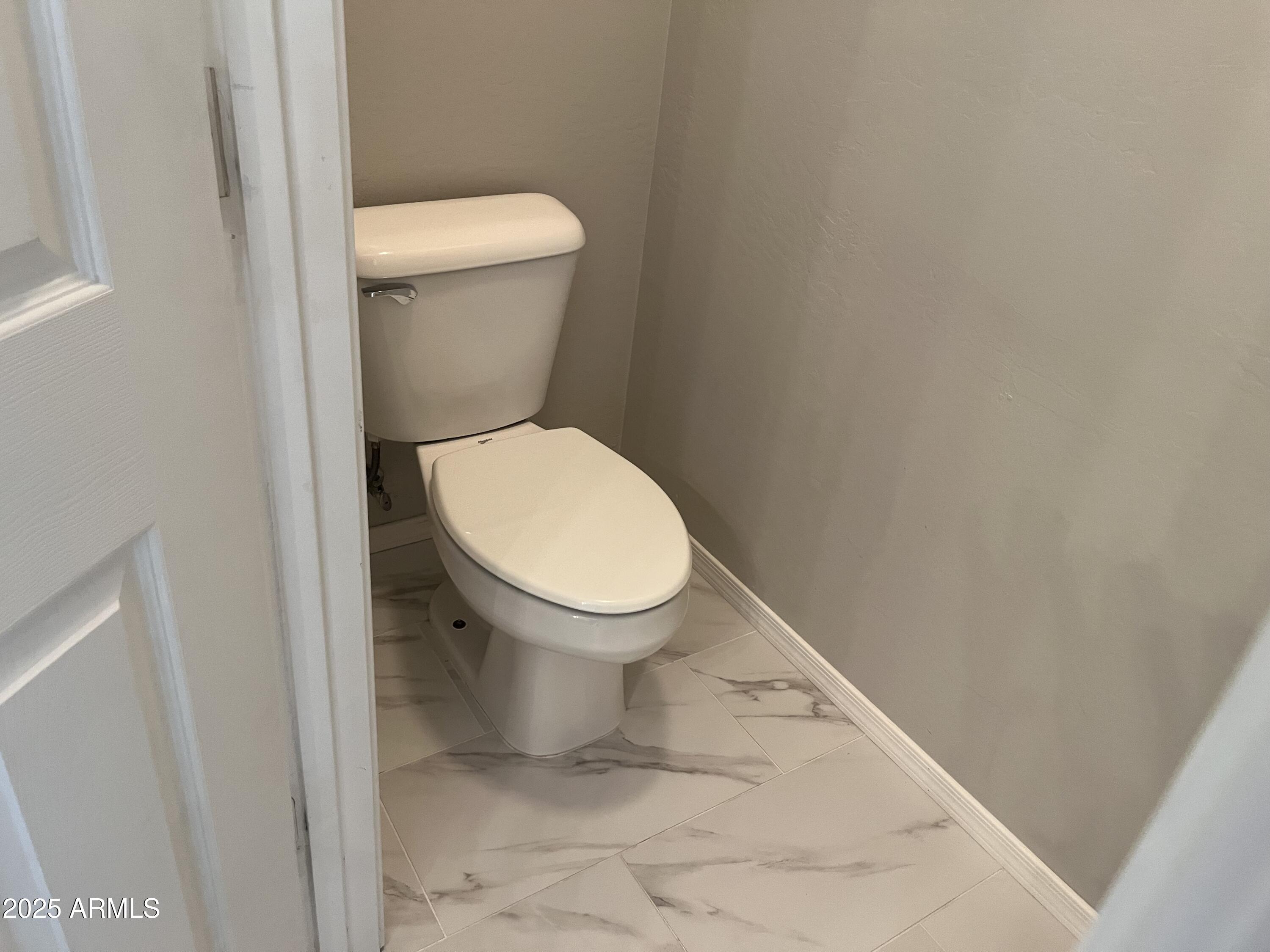 7007 West Carson Road Laveen, AZ 85339 - Photo 12 of 19 a white toilet sitting next to a white toilet