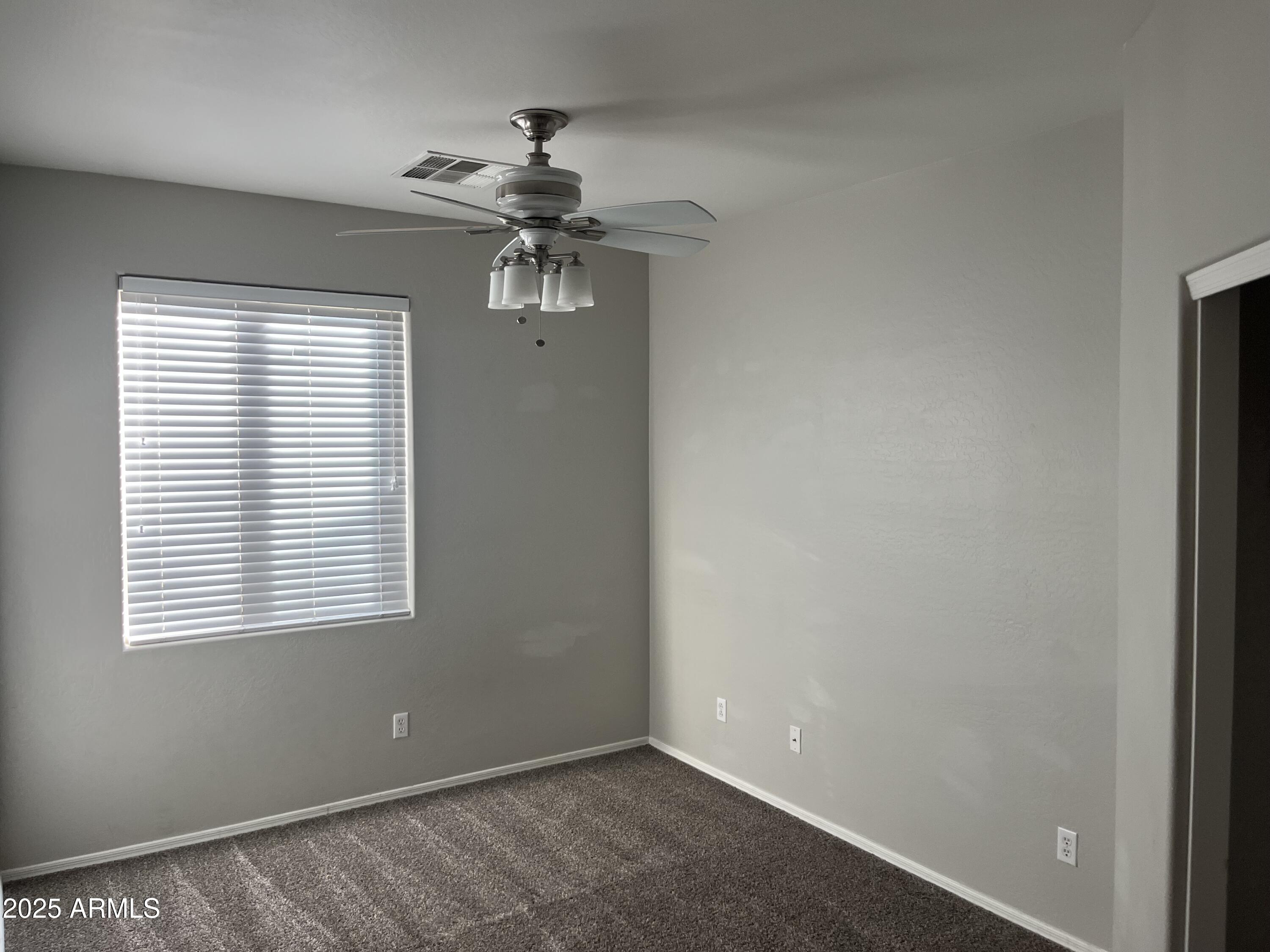 7007 West Carson Road Laveen, AZ 85339 - Photo 14 of 19 a view of room with a ceiling fan and a window