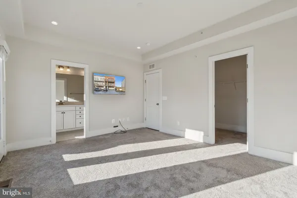 a bathroom with a sink shower and a mirror