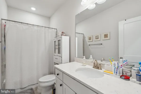 a bathroom with a sink toilet and mirror