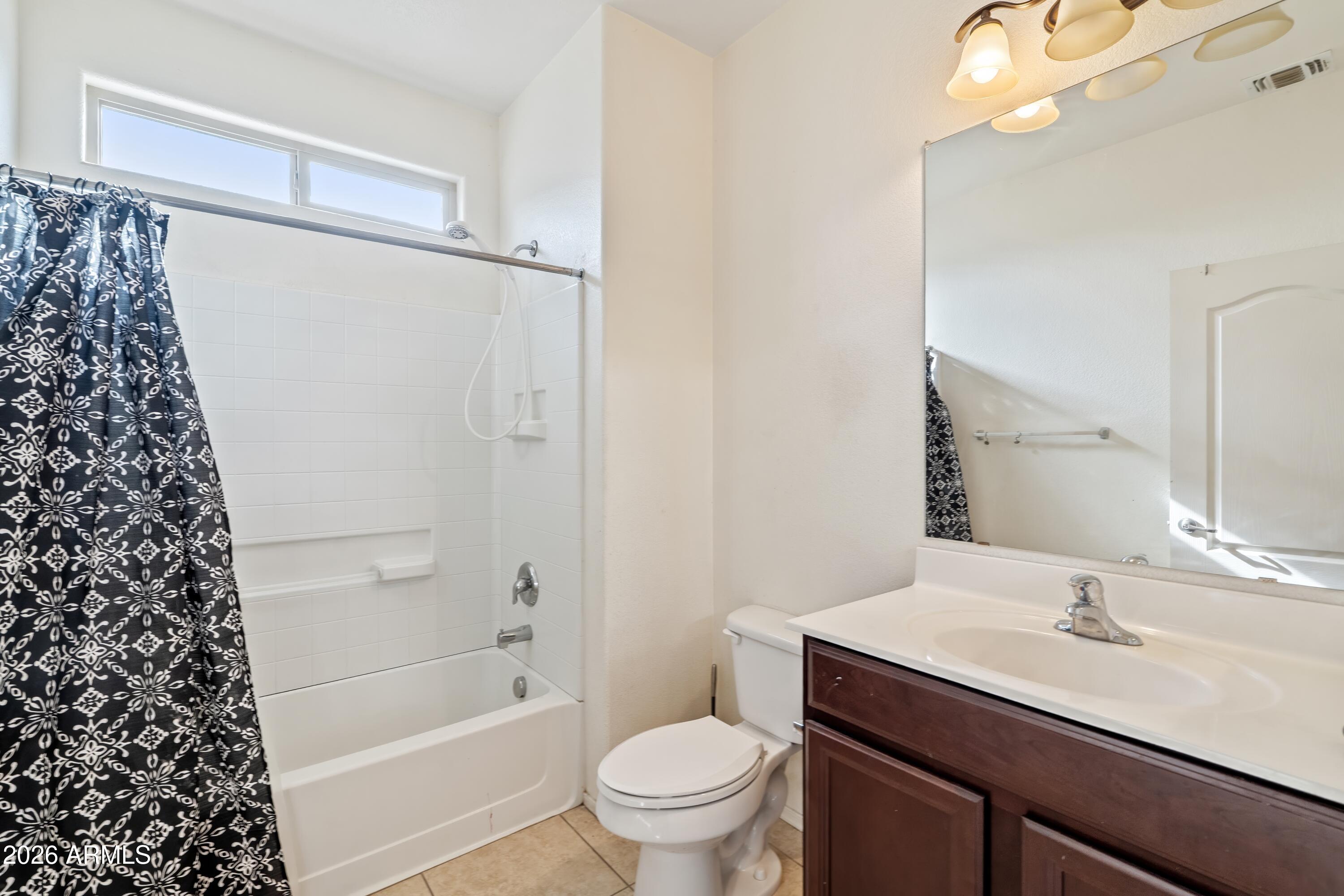 7634 West Apollo Road Laveen, AZ 85339 - Photo 12 of 34 a bathroom with a sink a toilet and a mirror
