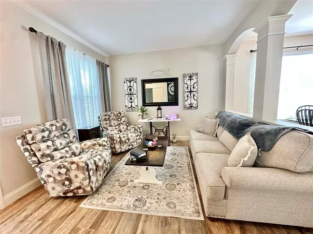 a living room with furniture and a mirror