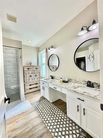 a bedroom with a bed and painting on the wall