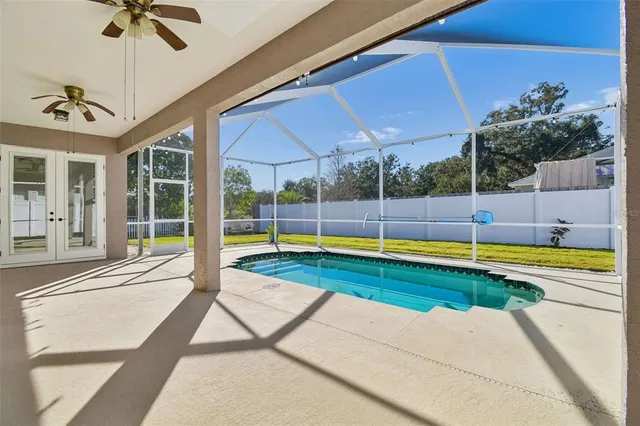 a view of a swimming pool with a yard