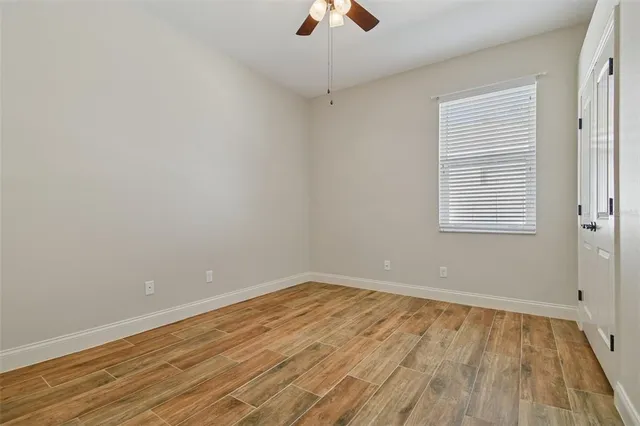 a view of a livingroom with a ceiling fan and window