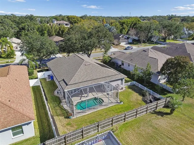 an aerial view of a house with pool and mountain view