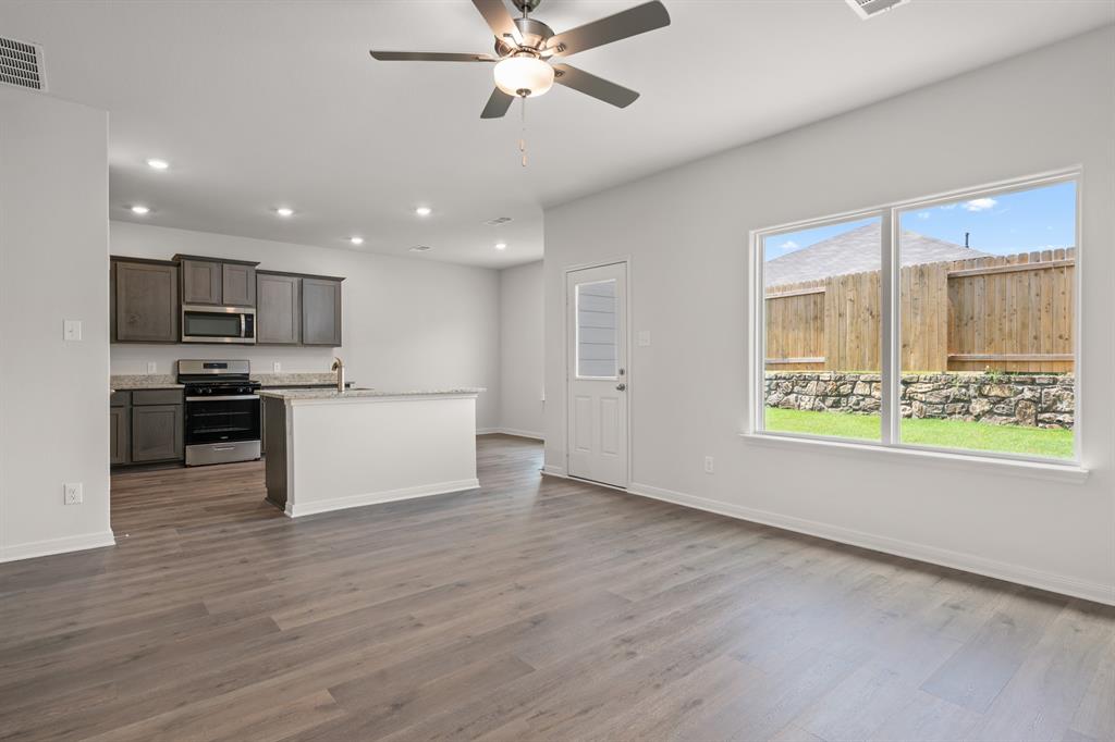 521-a D A D Crain Street Venus, TX 76084 - Photo 8 of 17 a view of kitchen with kitchen island wooden floor and stainless steel appliances